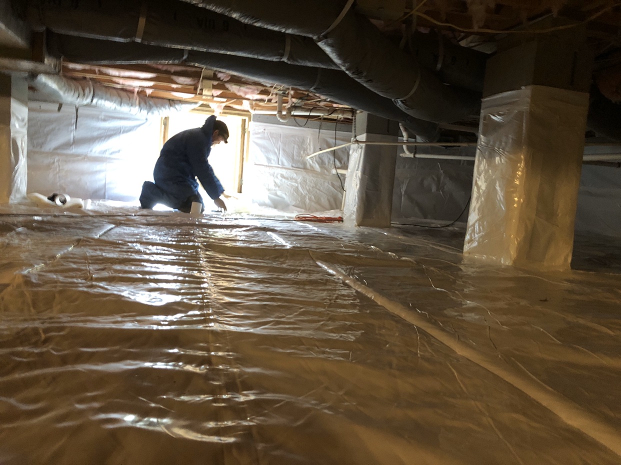 A man working in a space with air vents